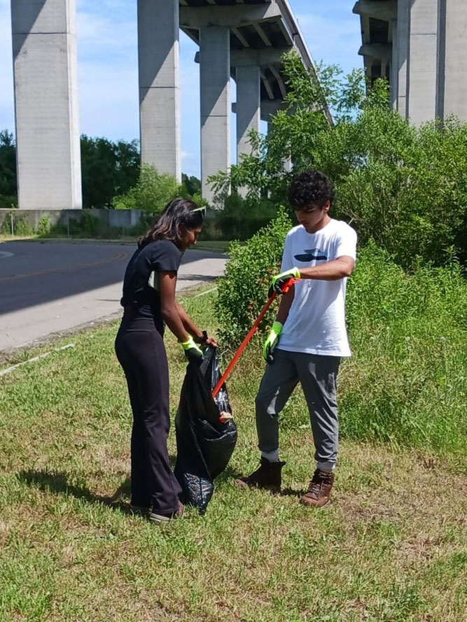 Volvo Penta interns, Aishwarya and Dev, removing plastics, paper and Styrofoam from the Newton Neck parking area.